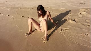 naked actress peeing on sand at beach while standing up